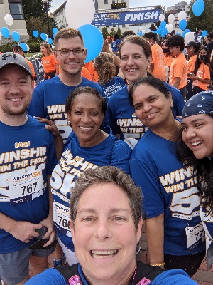 Photo of people smiling at a 5-k race