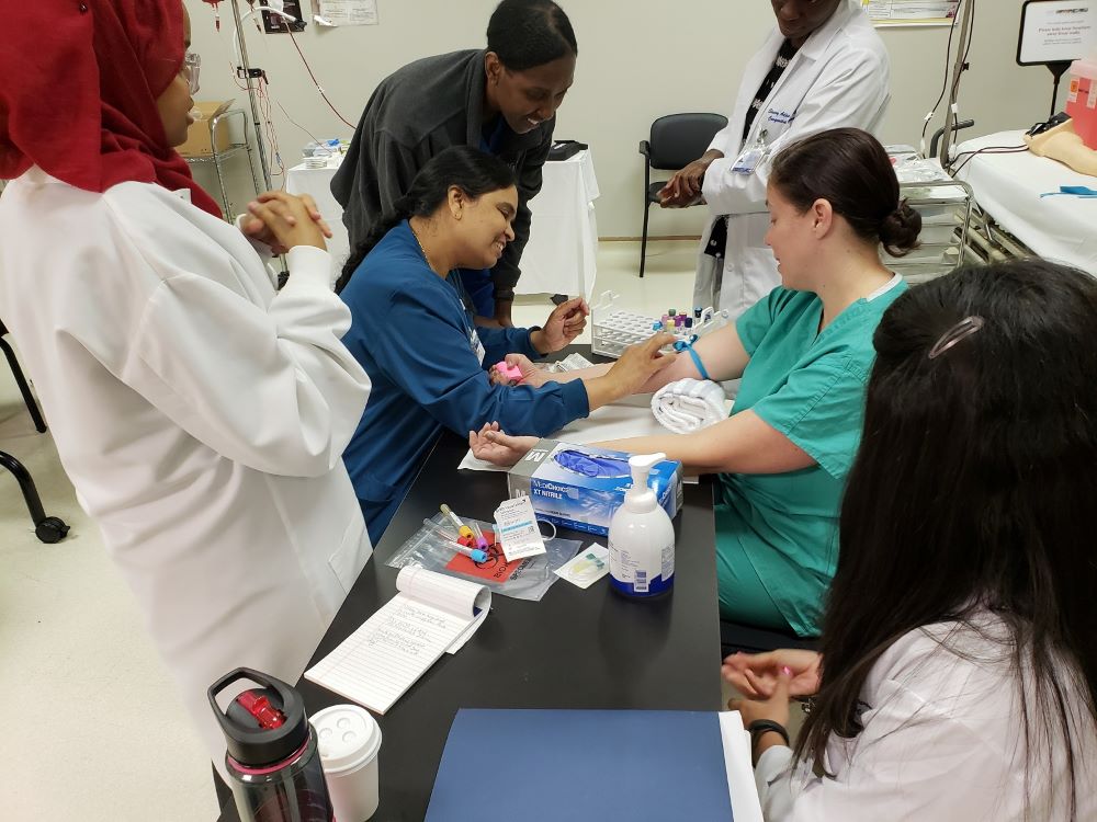 Health professionals performing phlebotomy