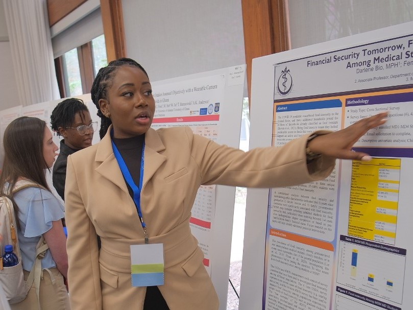 researcher presenting poster