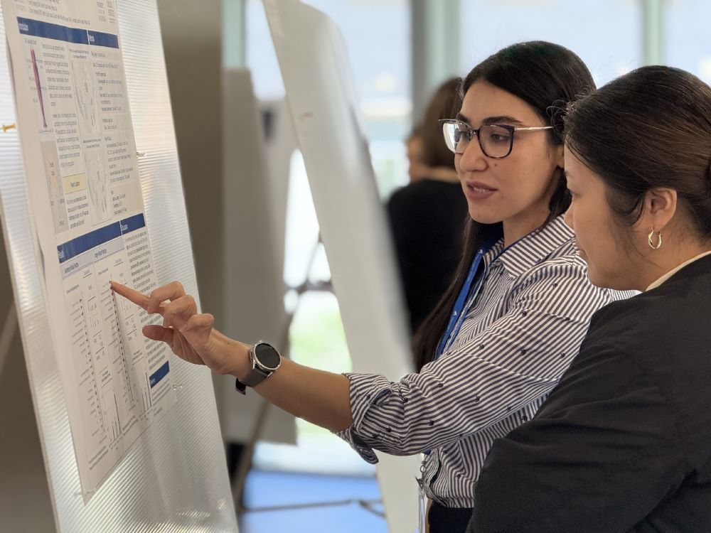 researcher presenting poster