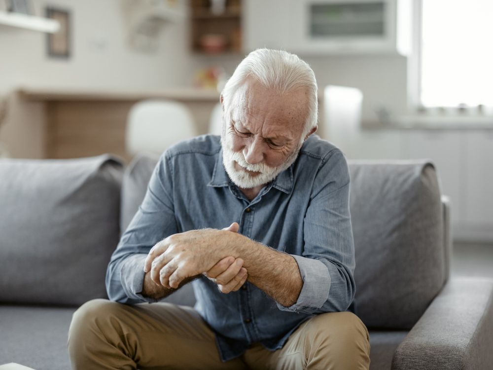 man looking at his swollen wrist