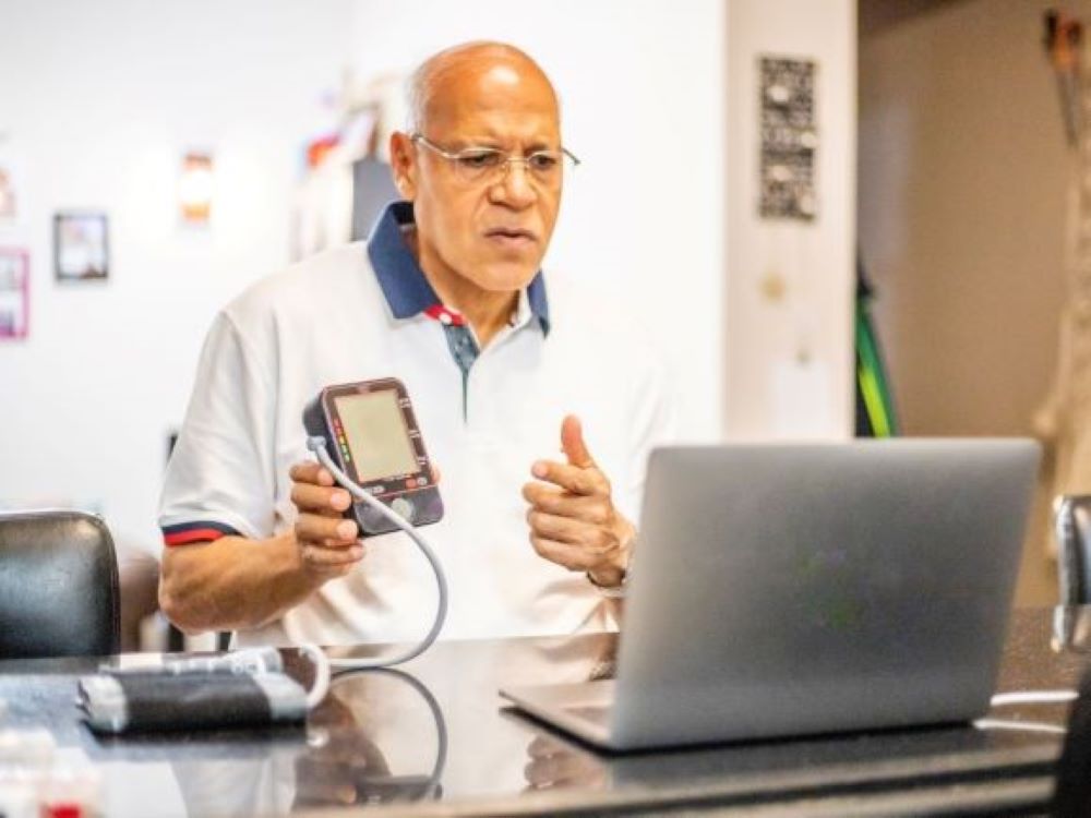 Man talking to doctor via laptop