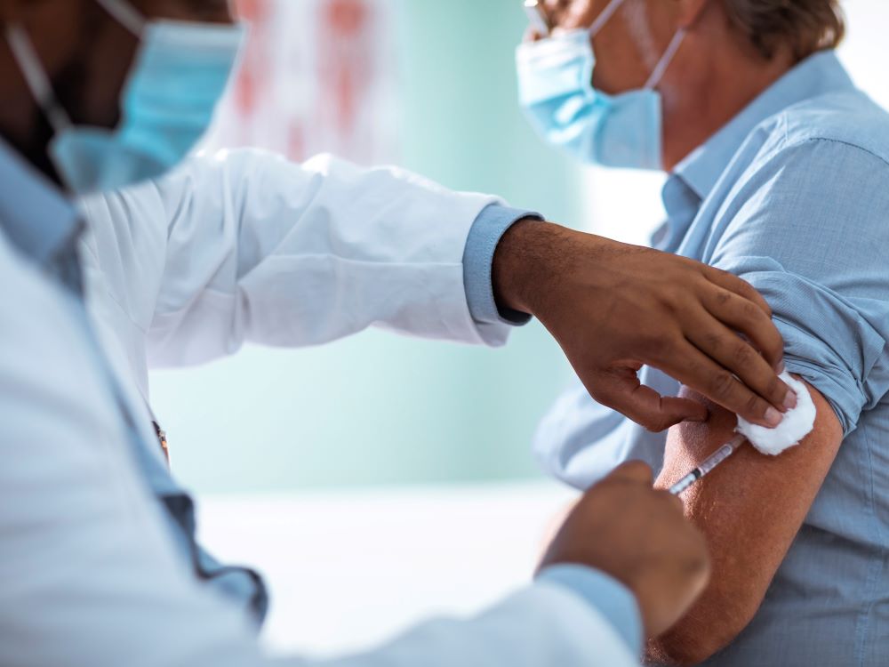 doctor vaccinating male patient