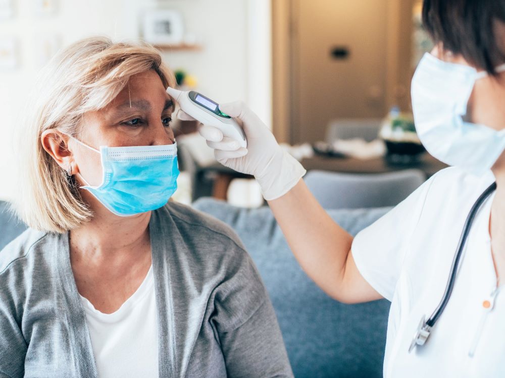 doctor taking patient's temperature