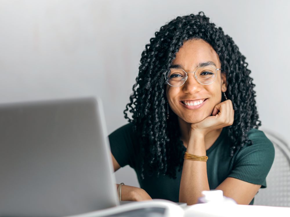 woman sitting by laptop