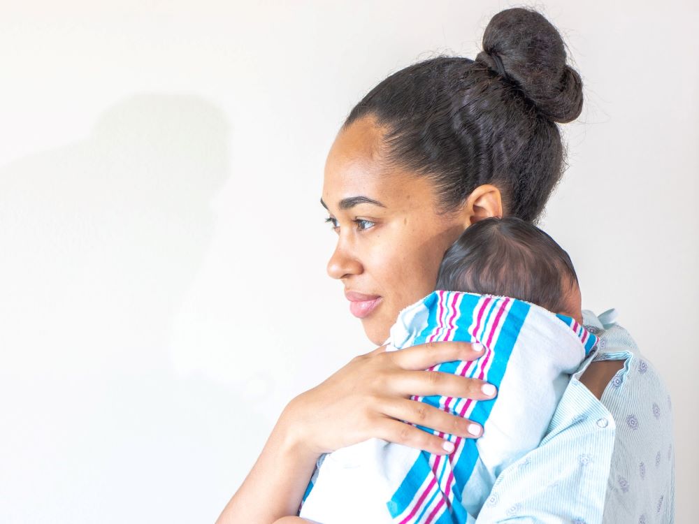 black mother holding her baby