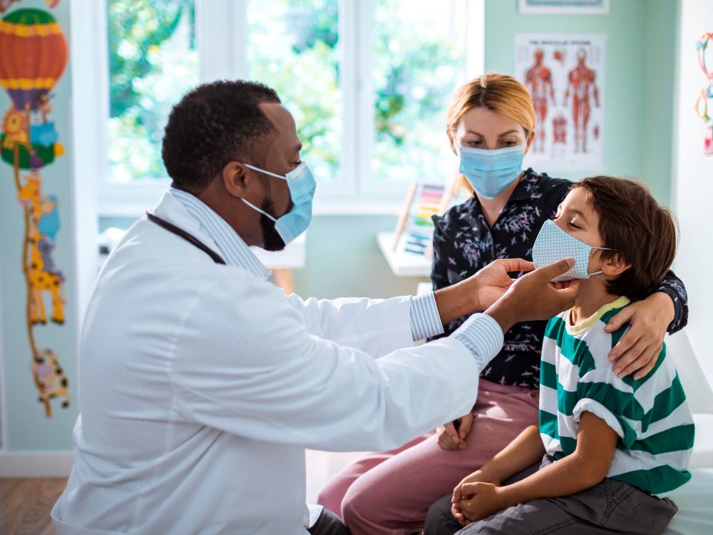 Doctor observing a child patient in doctor's office