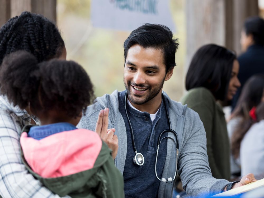 doctor with community members